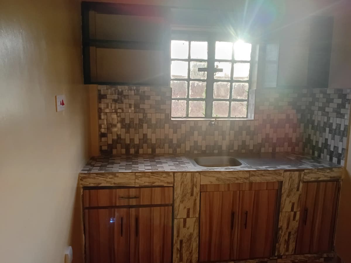 Basic kitchen with wooden cabinets and tiled backsplash