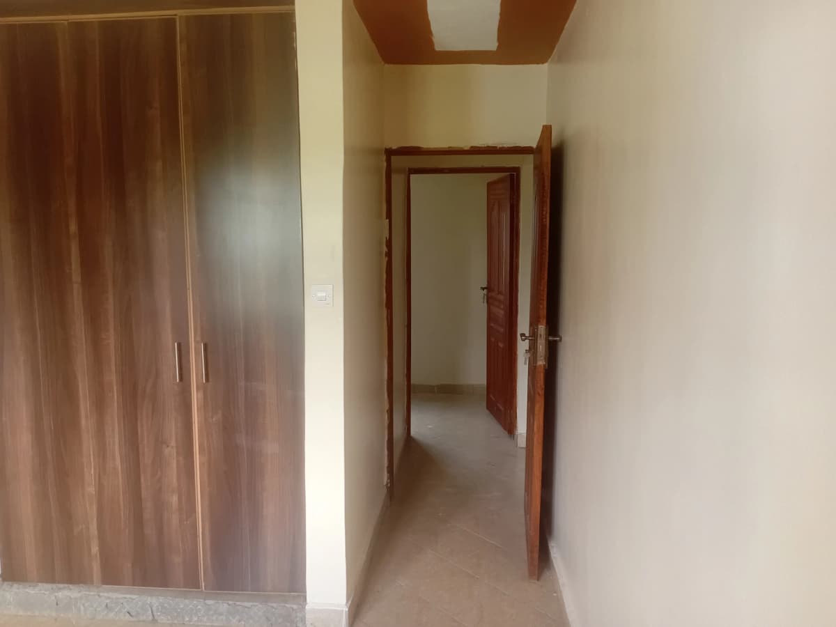 Empty hallway with wooden wardrobe and open doorway