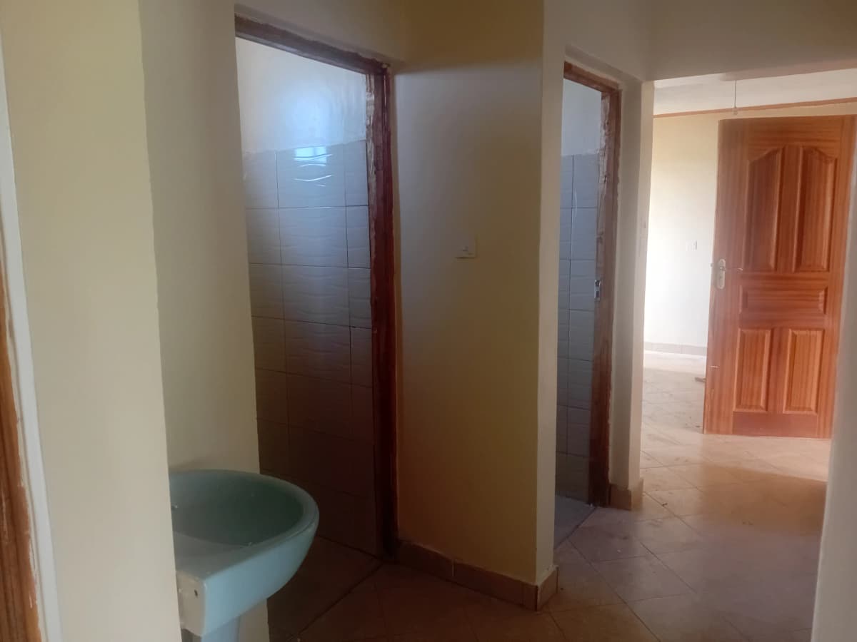 Basic bathroom with toilet and tiled shower enclosure