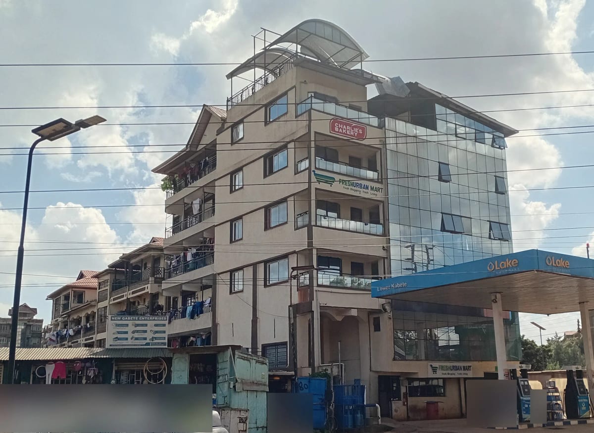 Multi-story residential building facade with street-level shops