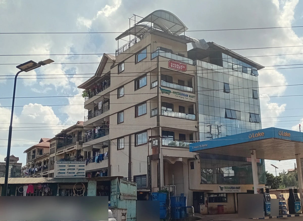 Multi-story residential building facade with street-level shops