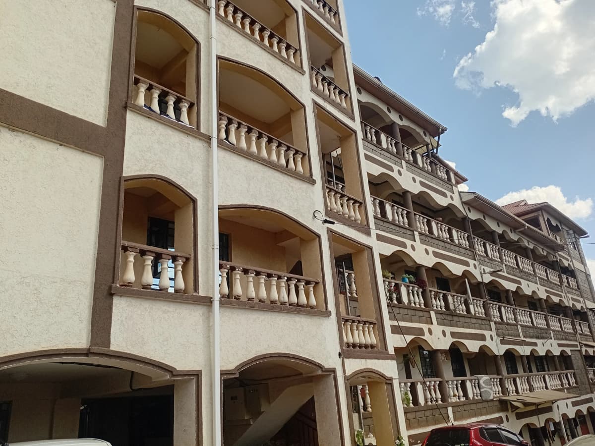Multi-story residential building facade with balconies and arches