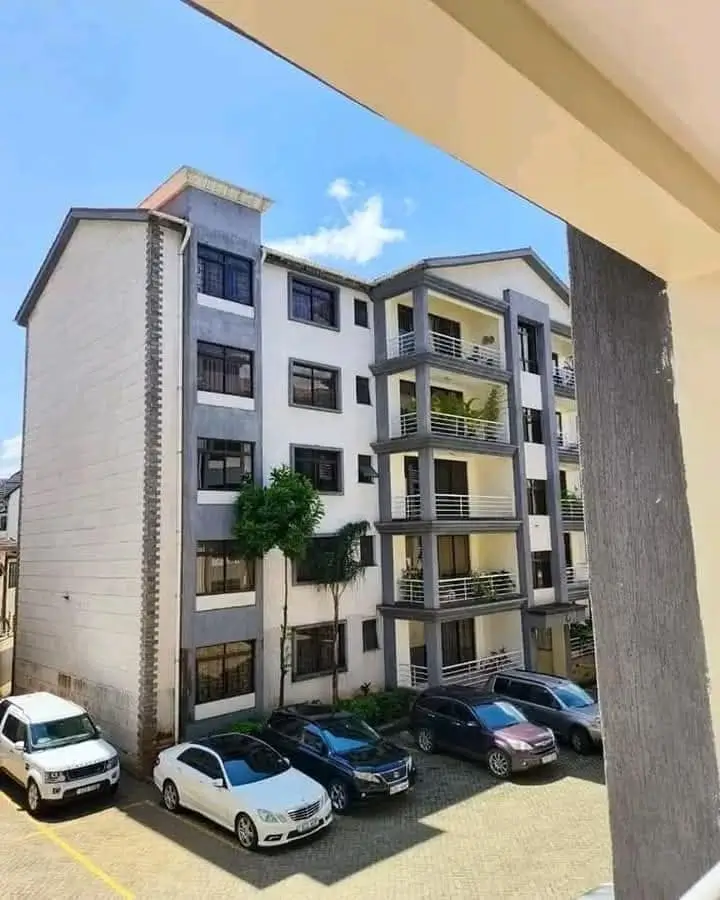 Modern residential apartment block with ground-level parking bays