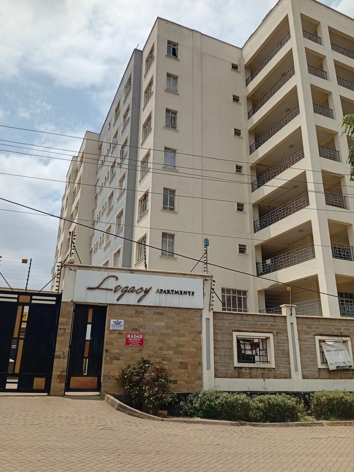 Multi-story apartment building facade with ground-level signage