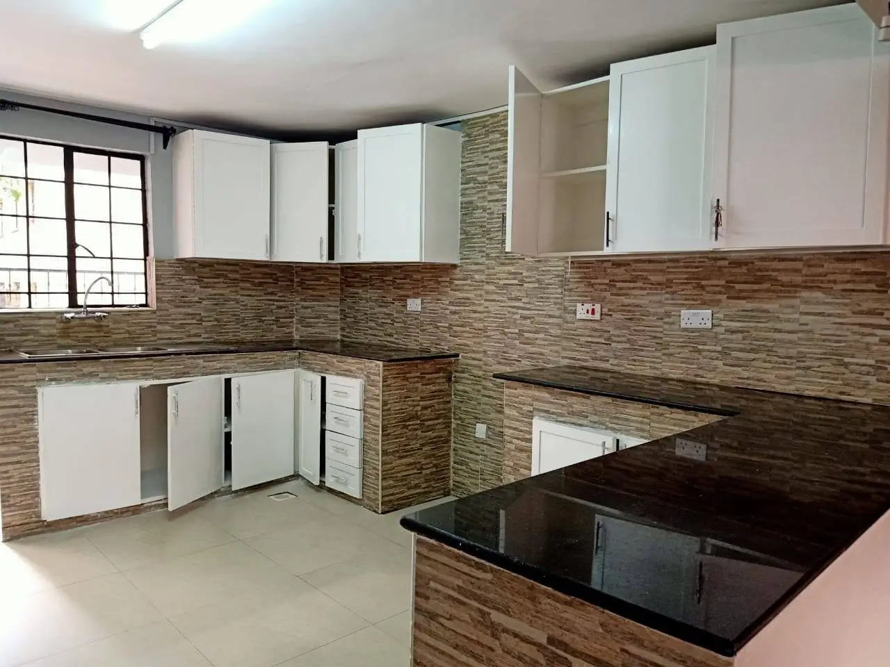 Modern kitchen with white cabinets and striped tile backsplash