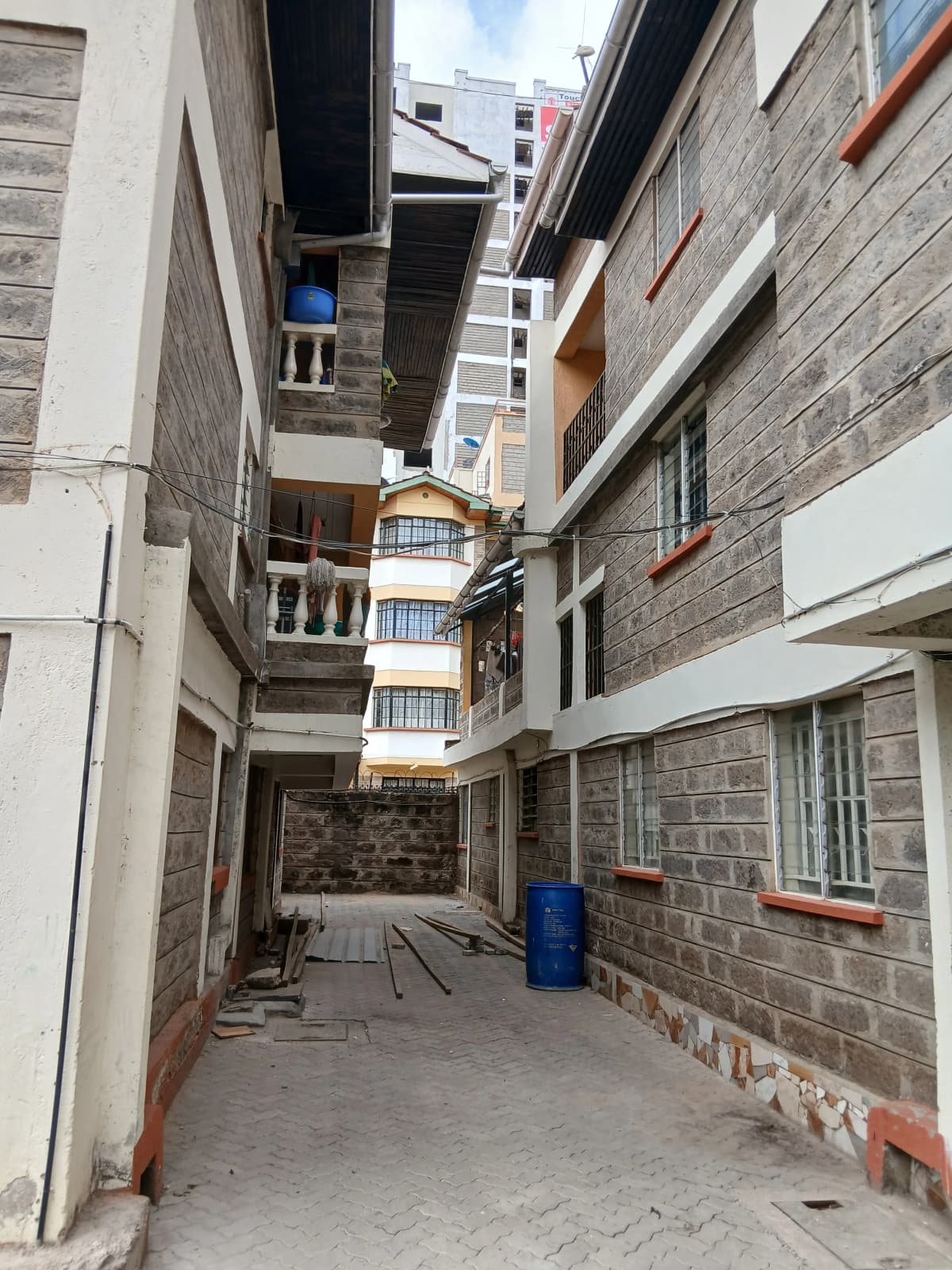 Narrow compound courtyard between residential buildings