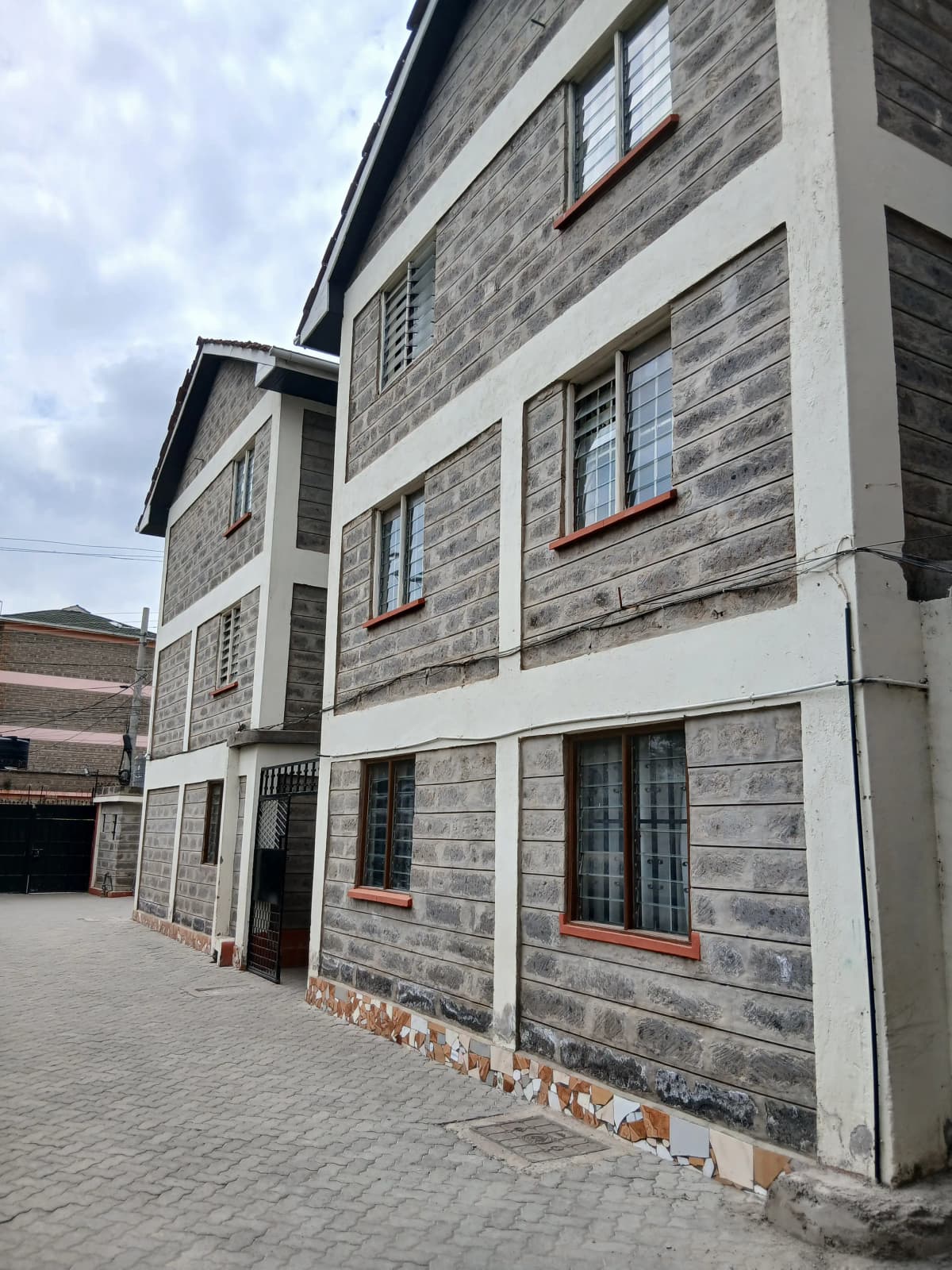 Modern multi-story residential building with stone facade