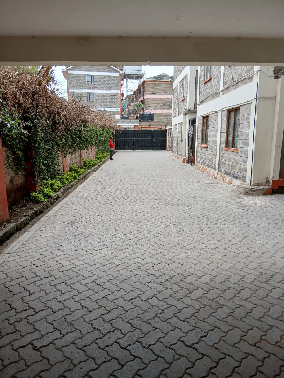 Paved driveway with herringbone brick pattern and side walls