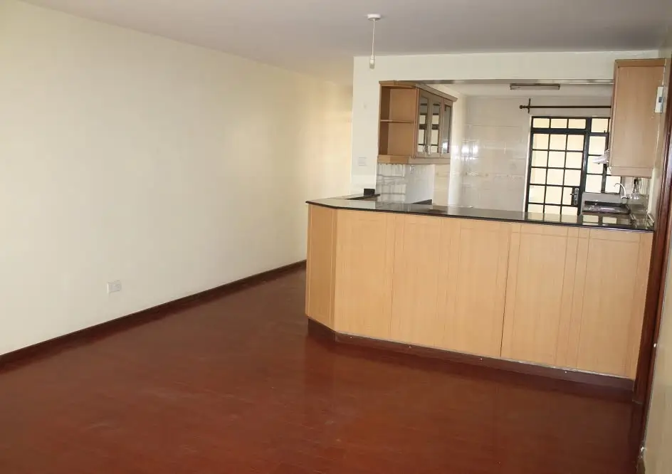 Open-plan living area with wooden kitchen counter partition