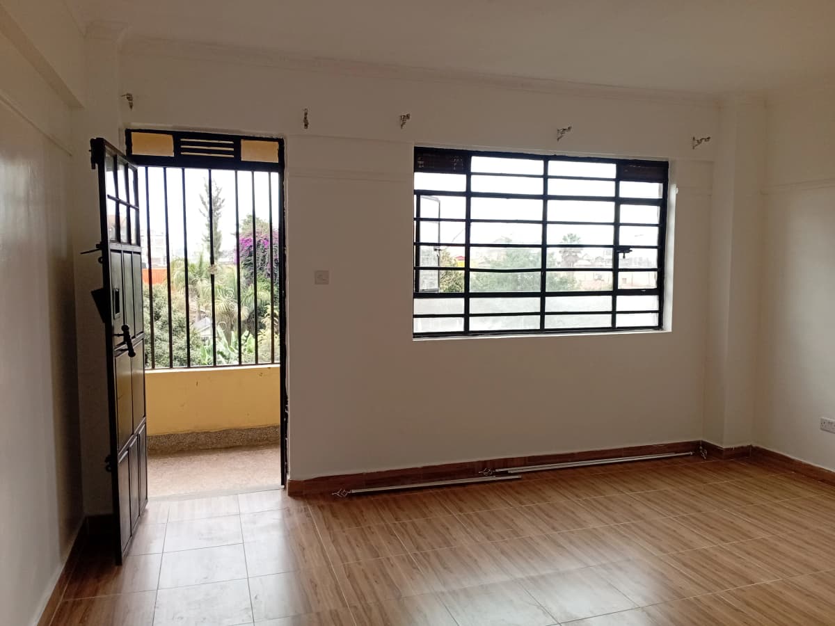 Spacious living room with wooden flooring and garden access