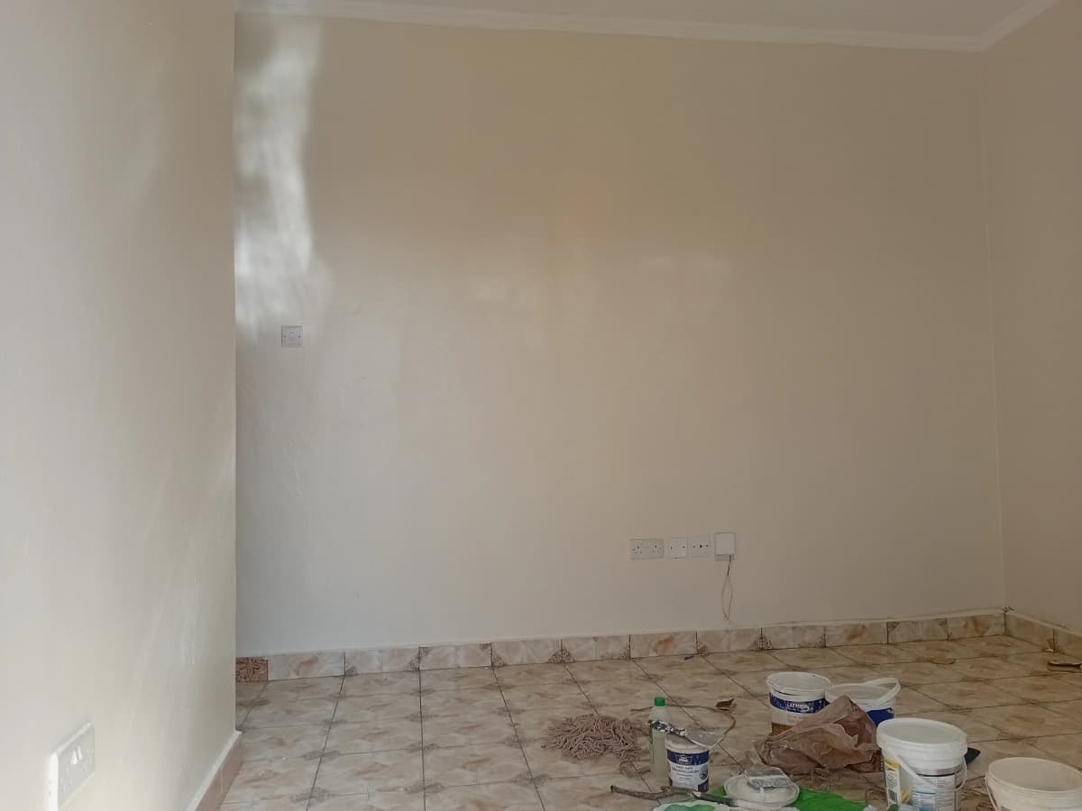 Empty room under renovation with tiled floor and construction materials