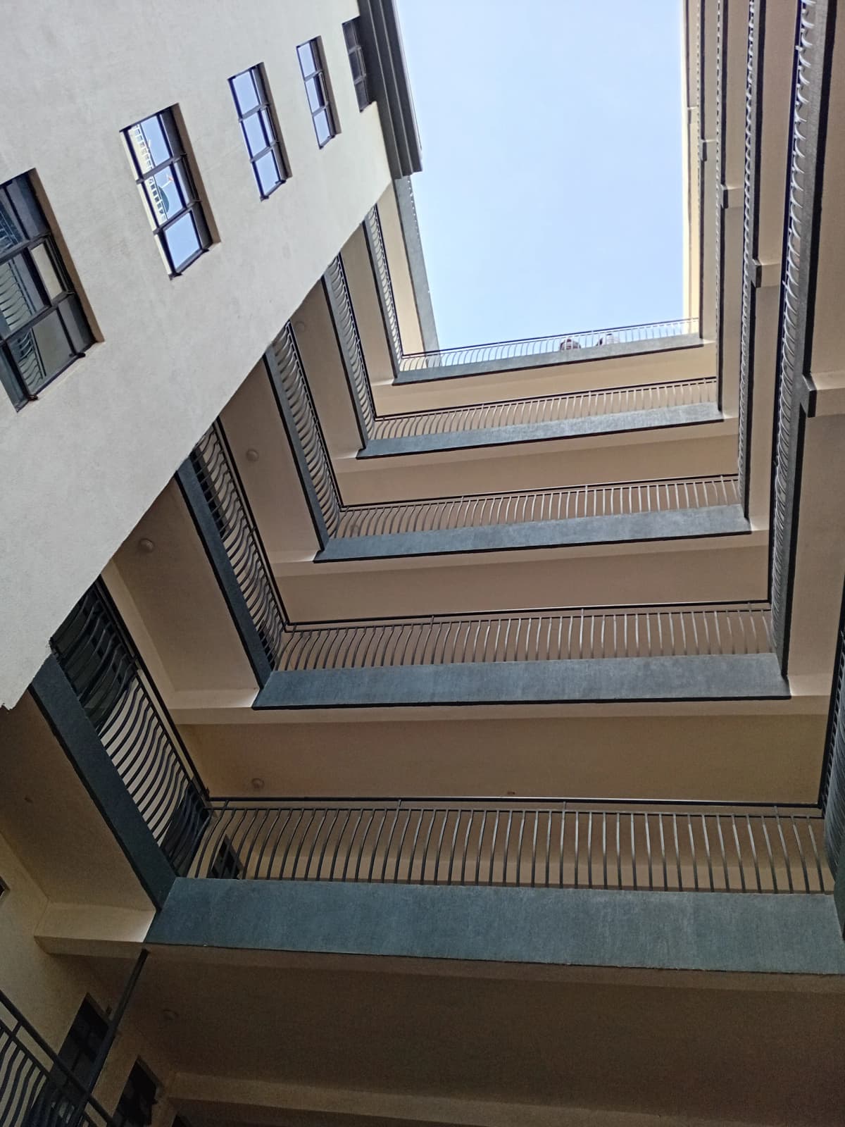 Multi-story residential building interior stairwell with natural light