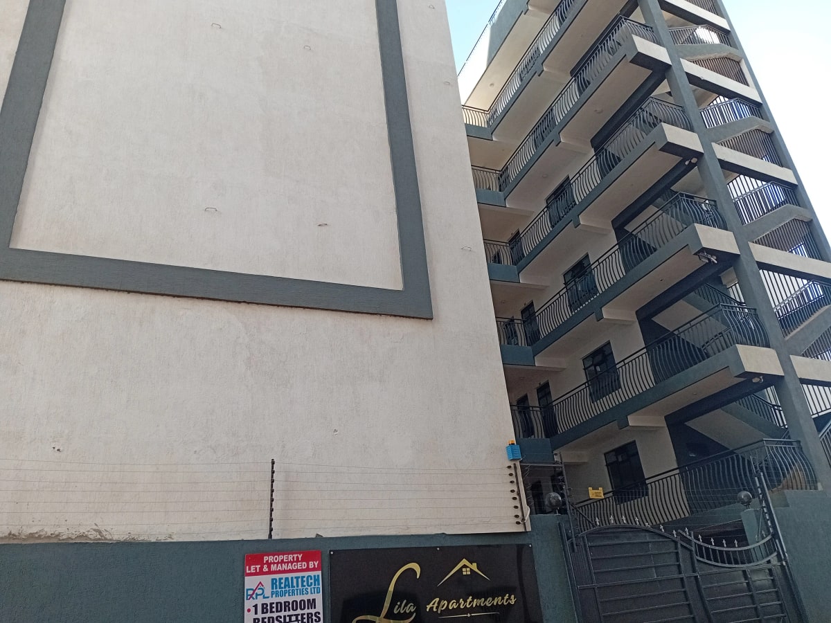 Multi-story apartment building facade with balconies and signage