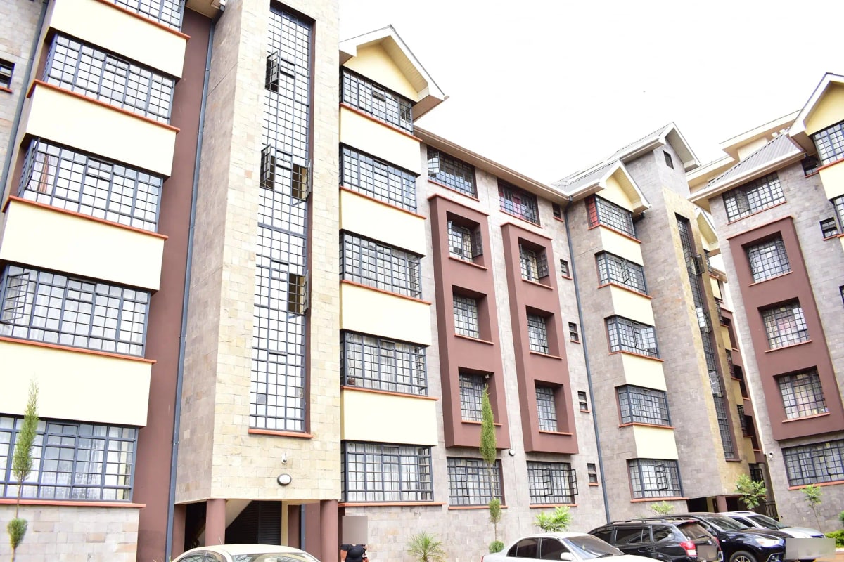Multi-story residential building facade with parking bays