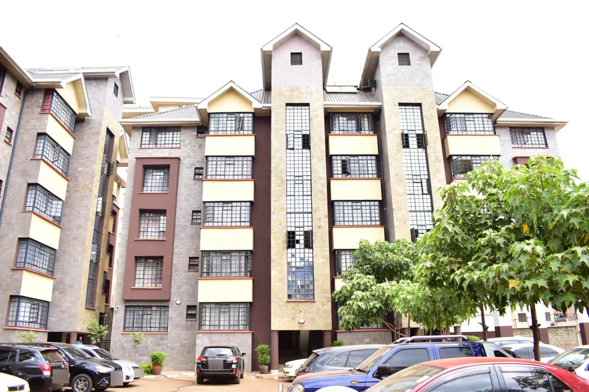 Multi-story residential apartment building with parking compound