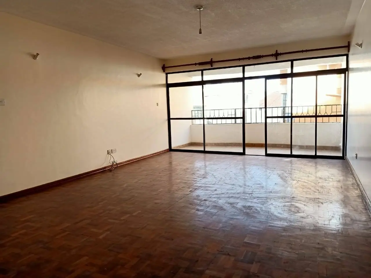 Spacious living room with large sliding glass doors to balcony