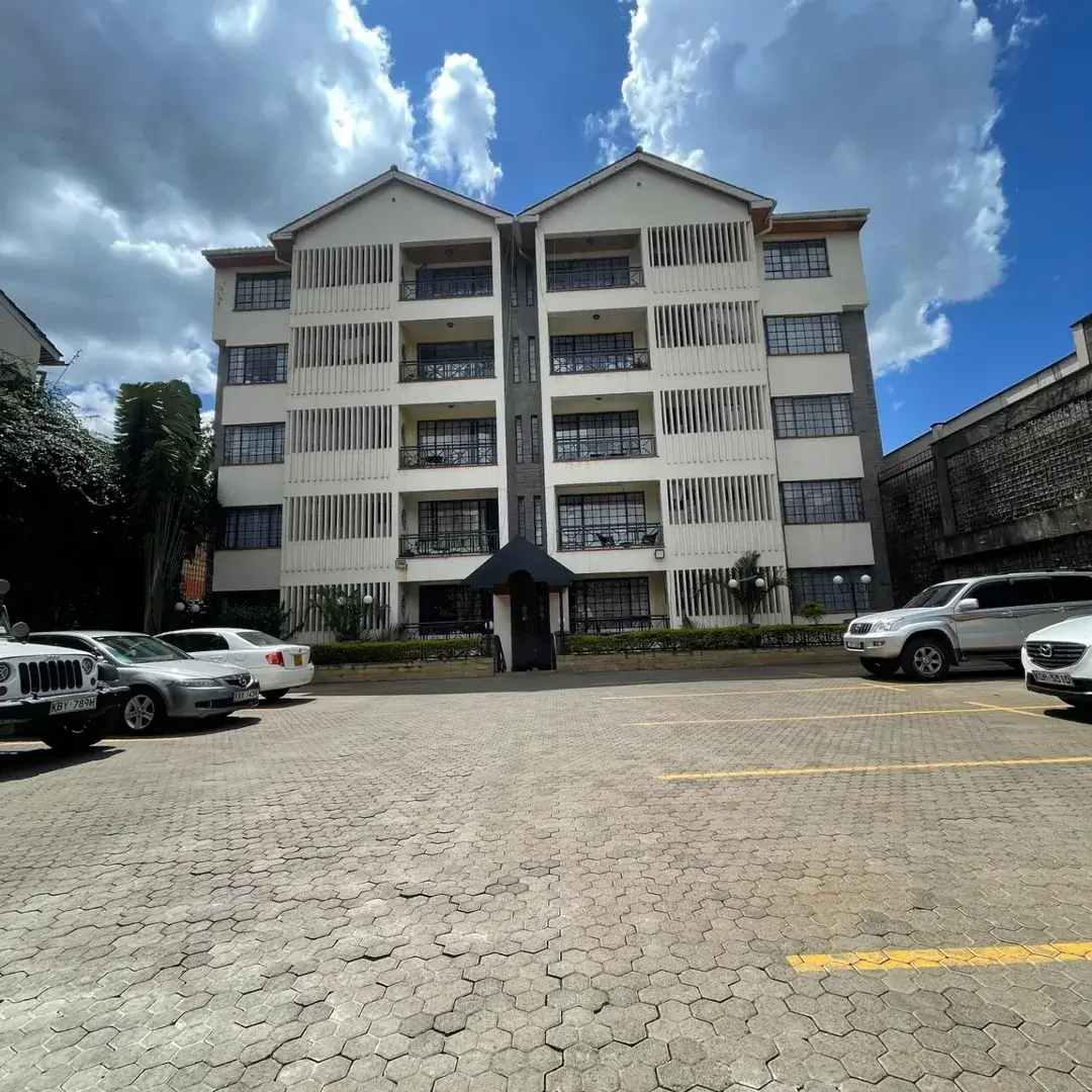 Multi-story residential building with paved parking compound