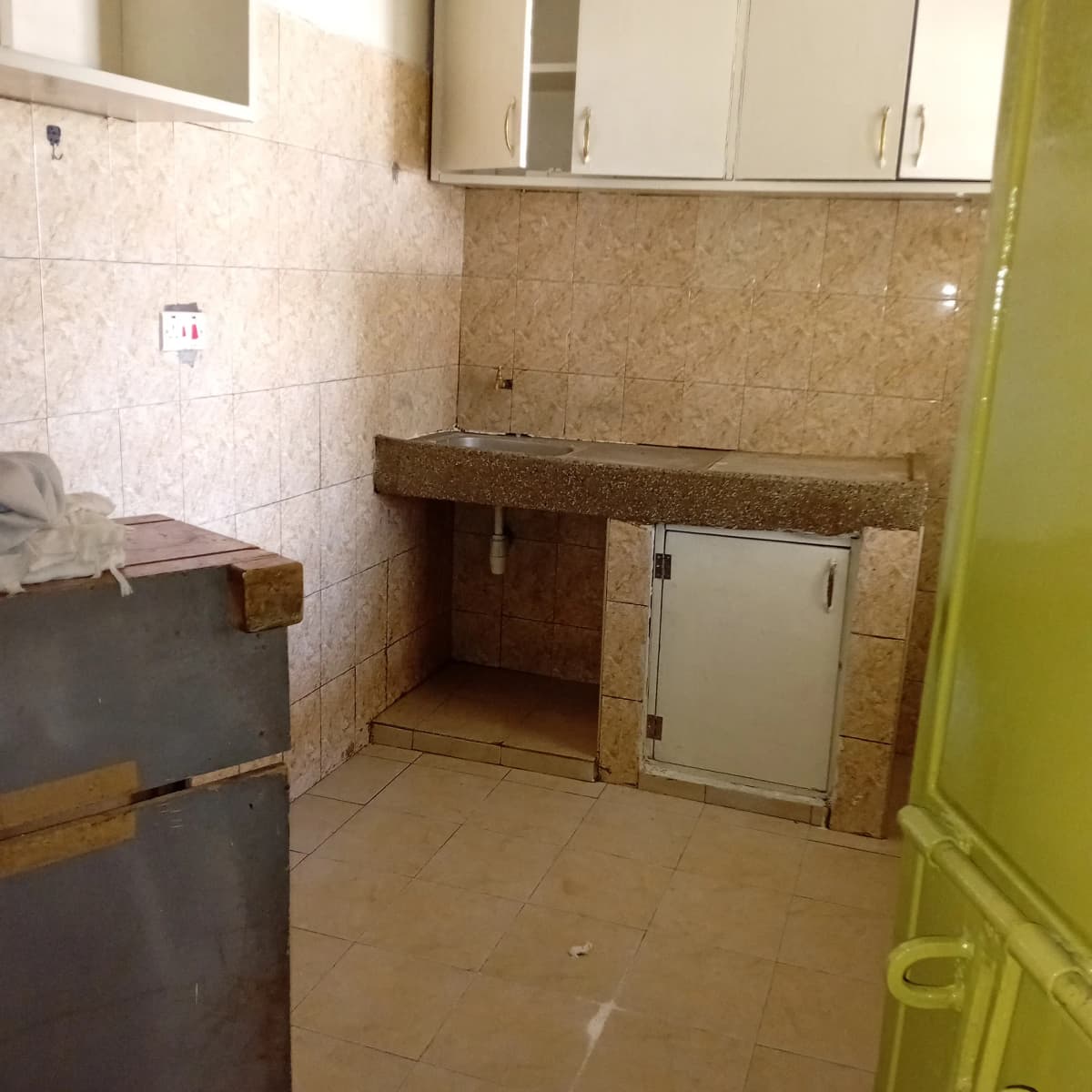 Basic kitchen with granite countertop and storage cabinets