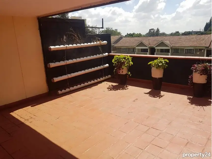Spacious balcony with potted plants and countryside views