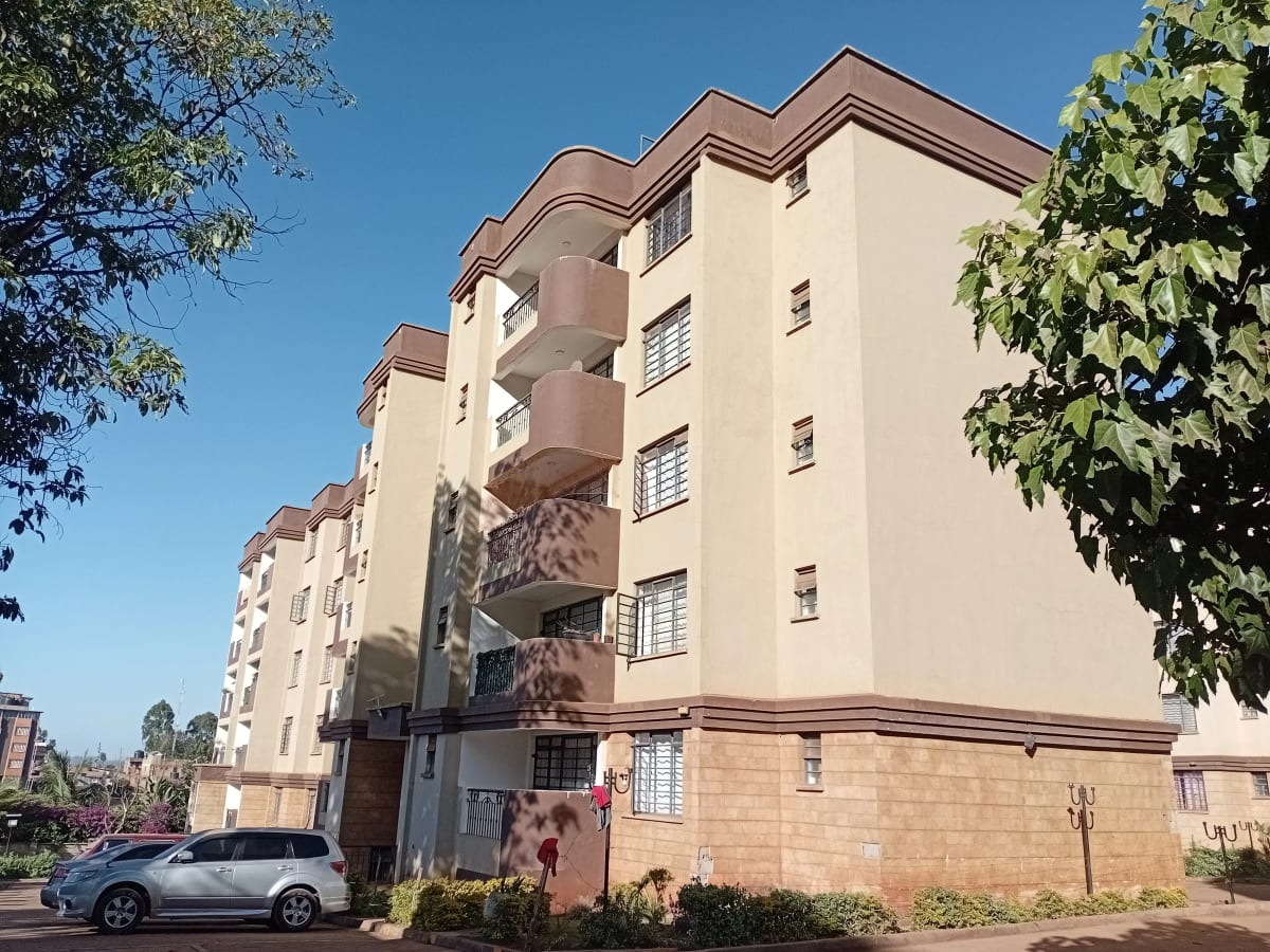 Multi-story residential apartment building with manicured grounds