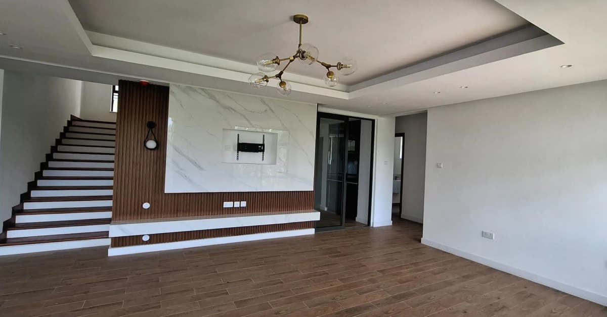 Modern lobby with staircase, wooden accent wall, chandelier
