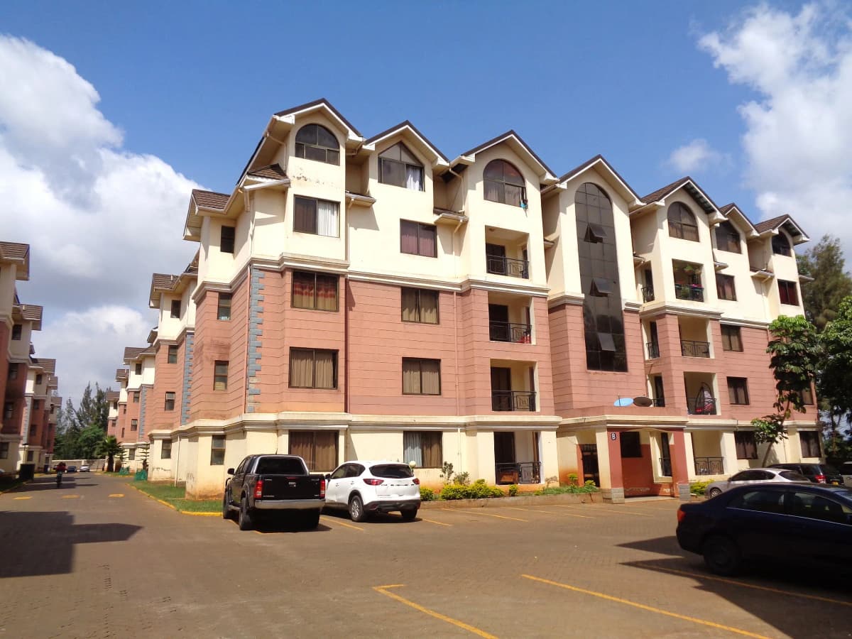 Multi-story residential building with cream and brick facade