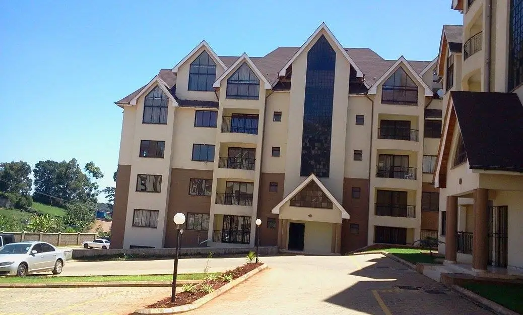 Multi-story residential building facade with pitched roofs