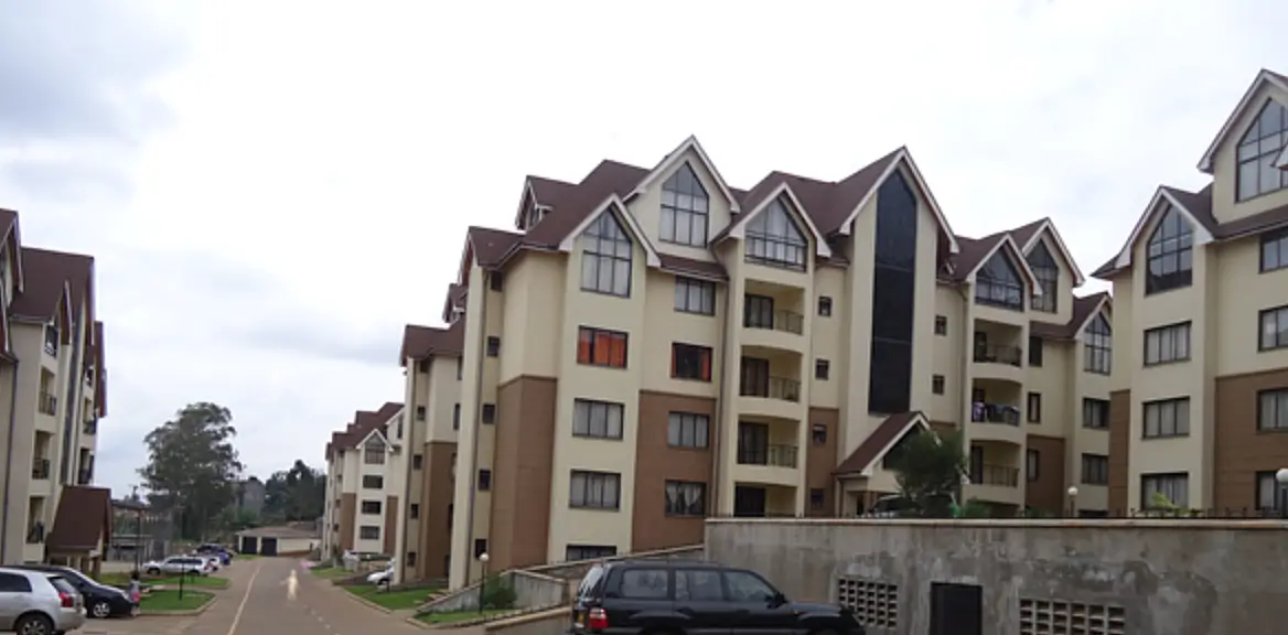 Multi-story residential complex with gated entrance and parking