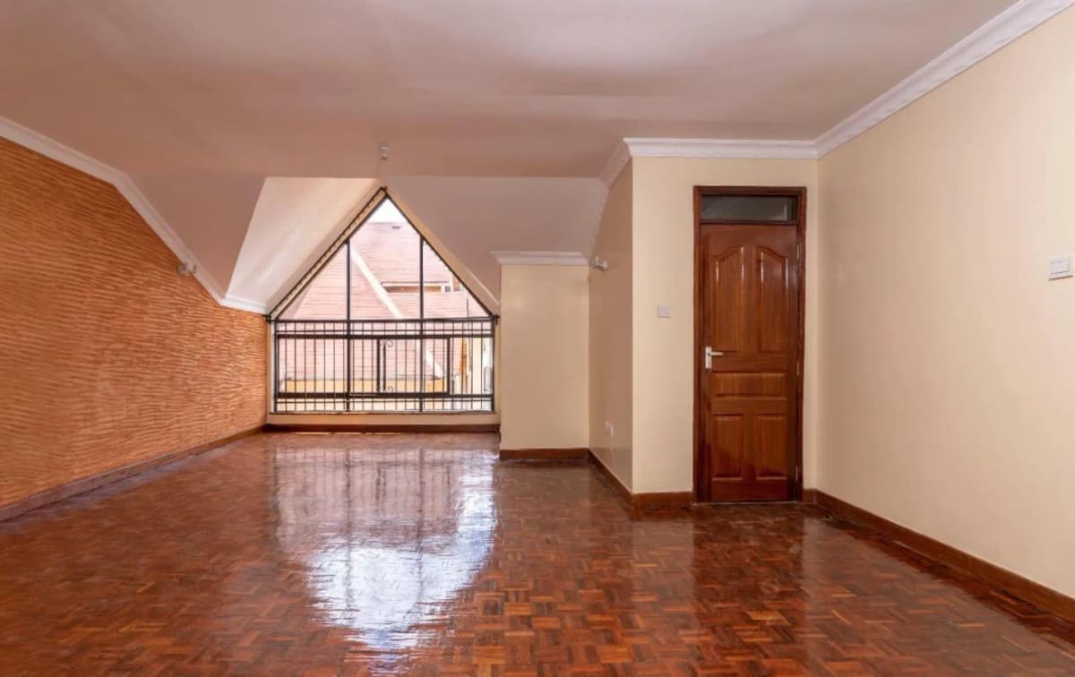 Spacious living room with polished wooden floors and high ceilings