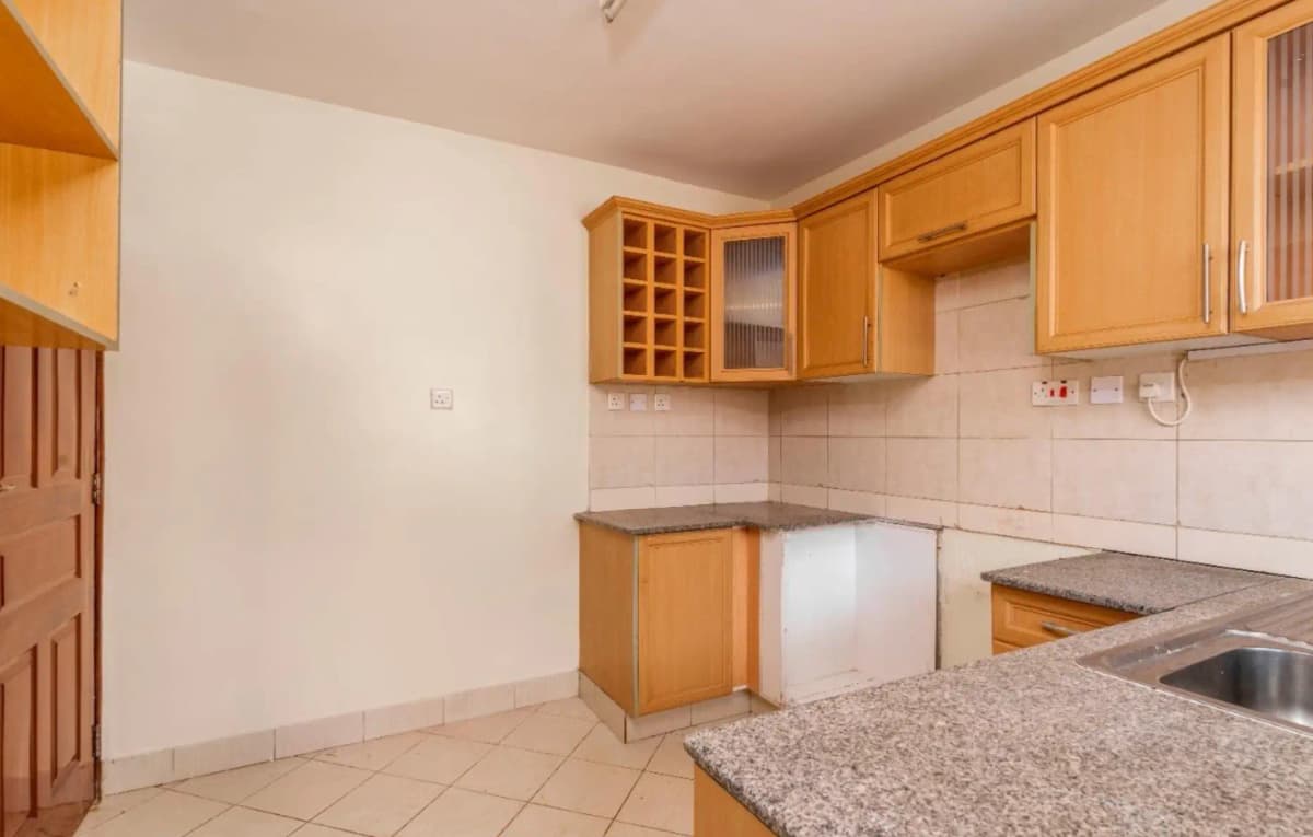 Spacious kitchen with wooden cabinetry and granite countertops