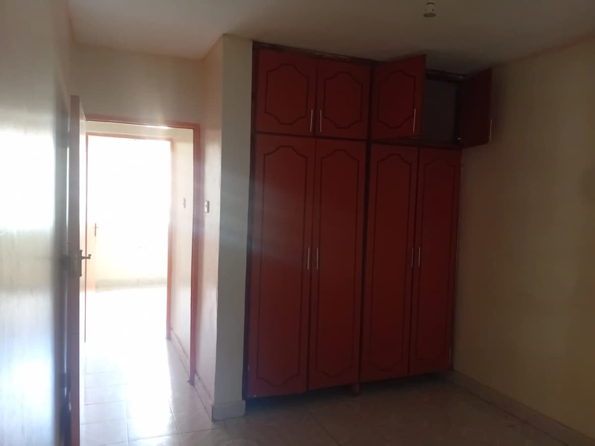 Bedroom with red built-in wardrobe and natural light entry