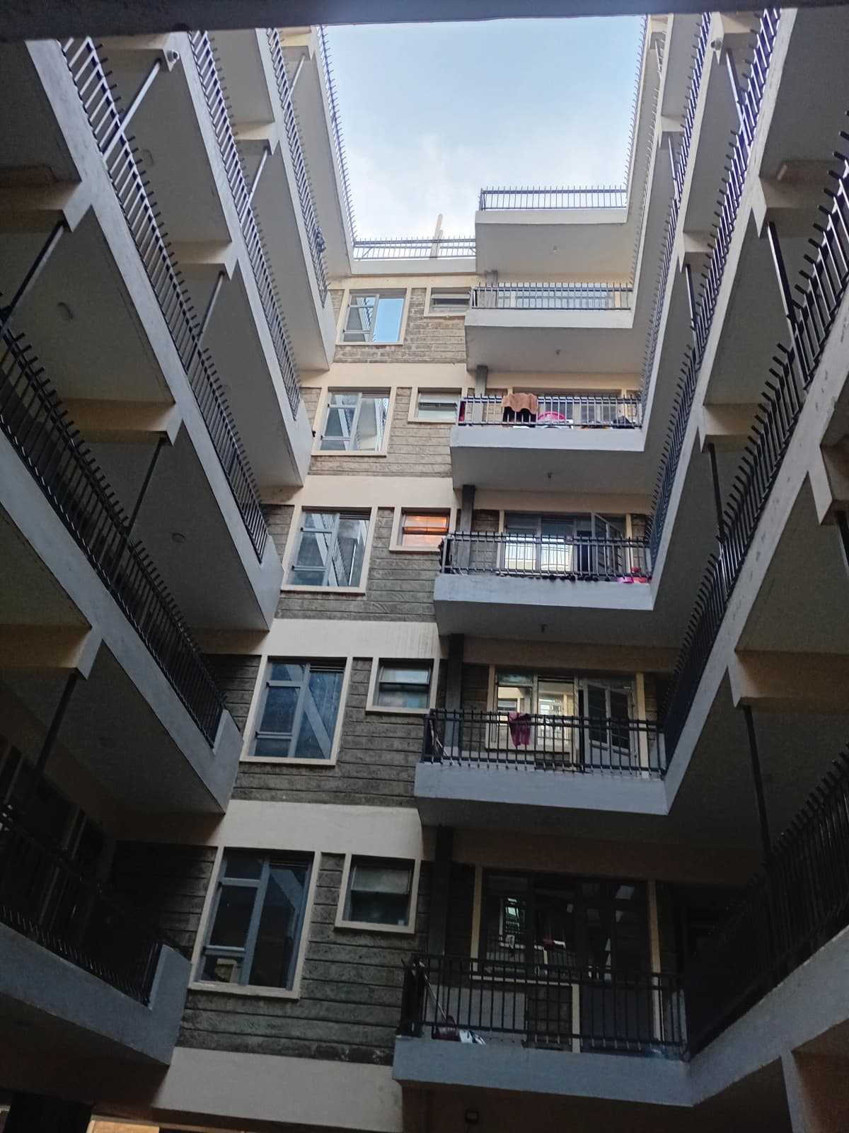 Multi-story apartment building interior courtyard view upward