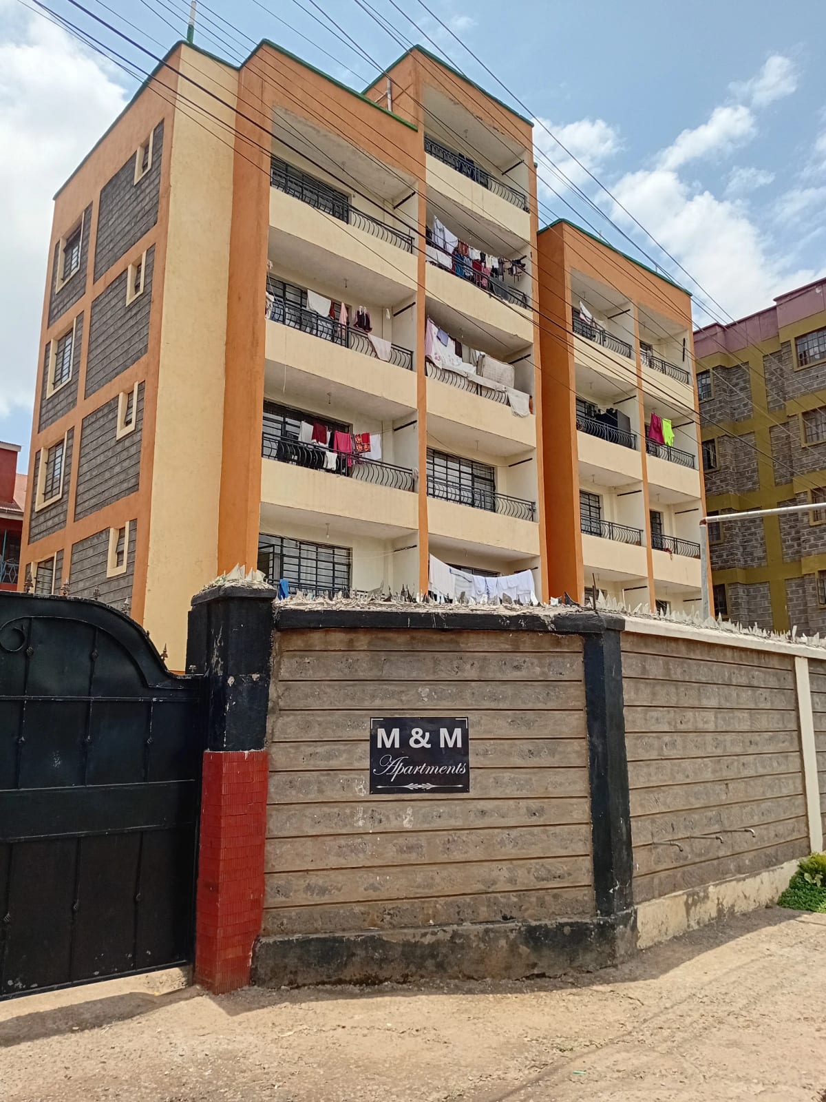 Multi-story residential apartment building with orange facade