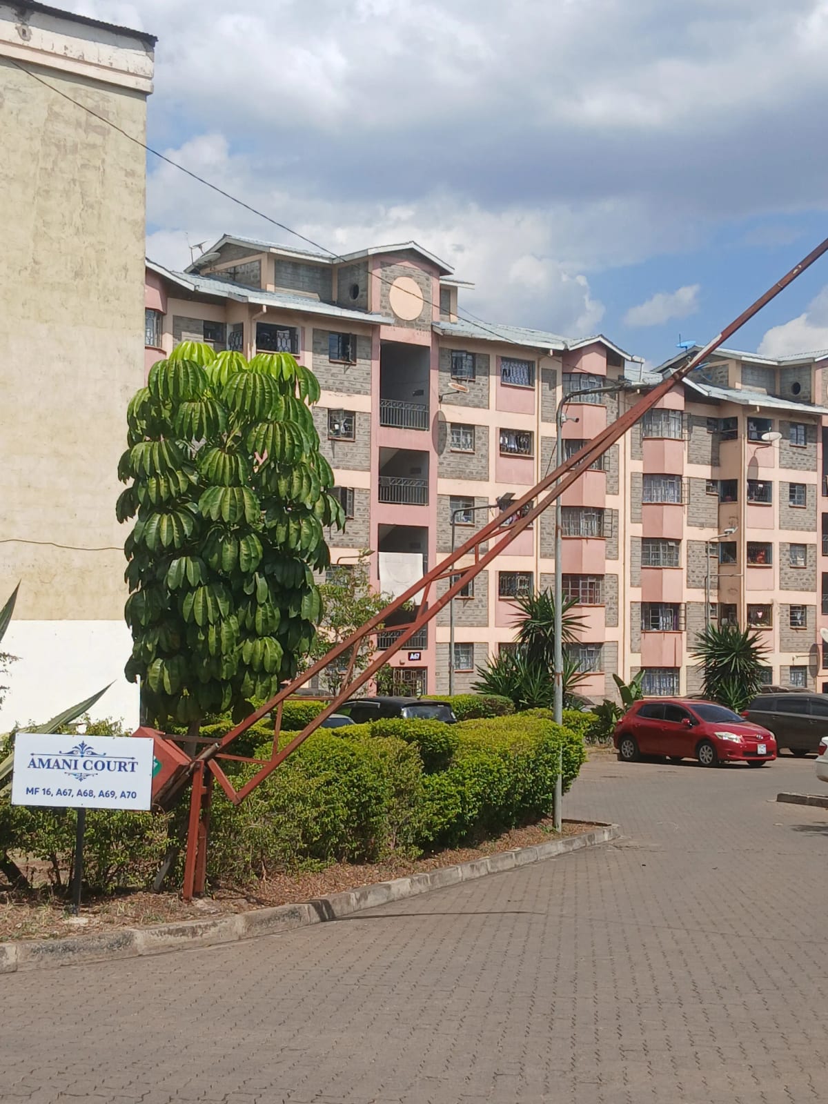 Multi-story residential building with manicured compound grounds