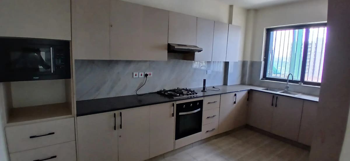 Modern fitted kitchen with black countertops and built-in appliances