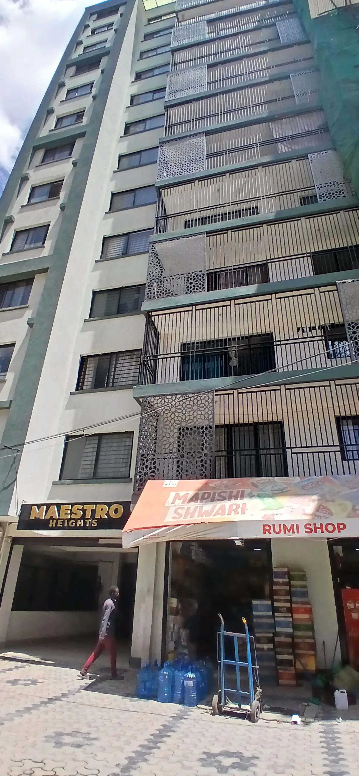Multi-story residential building facade with ground floor shops