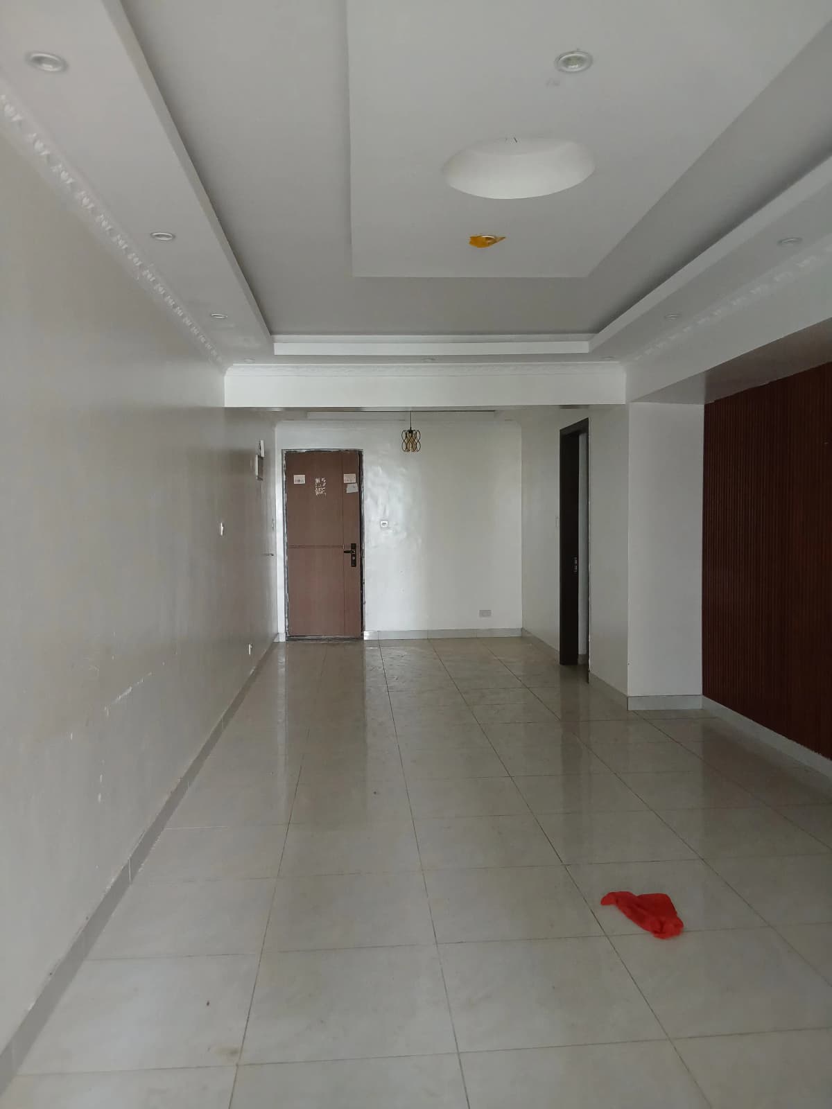 Spacious empty living room with polished tile flooring