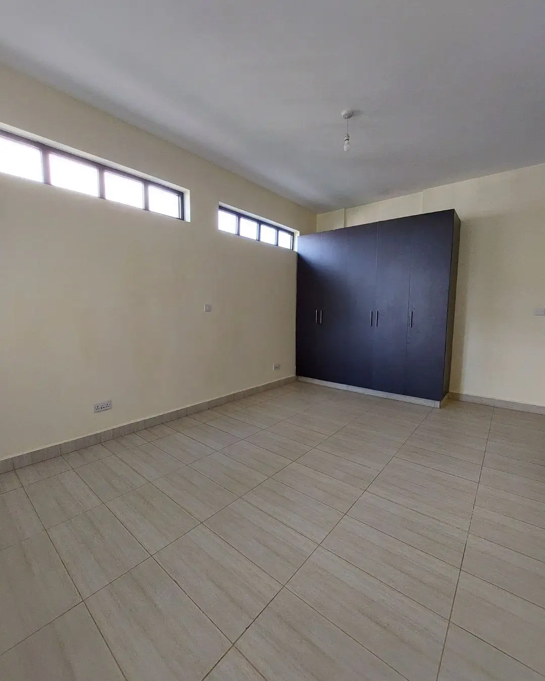 Spacious bedroom with built-in wardrobe and natural light