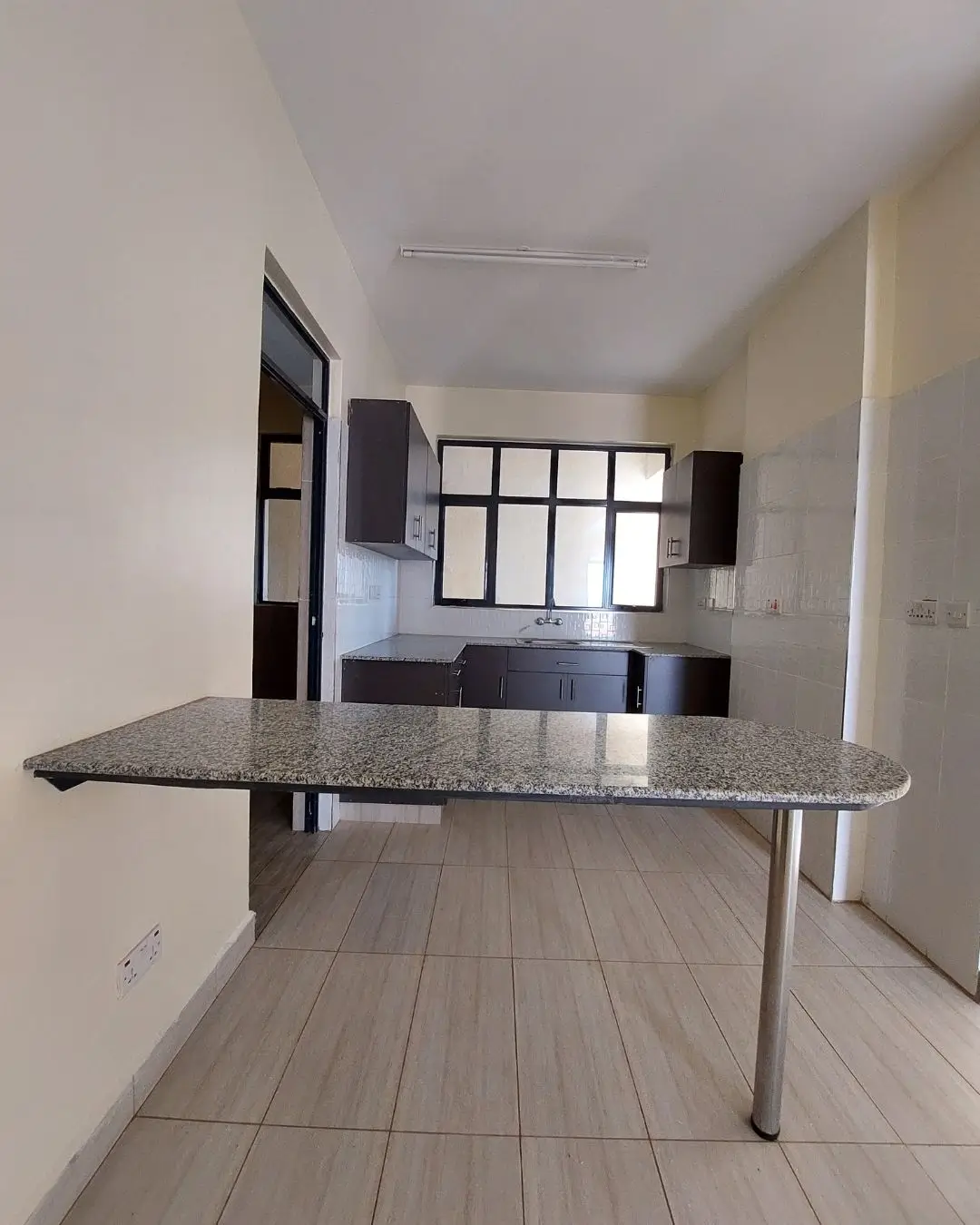 Open-plan kitchen with granite counter and dining bar