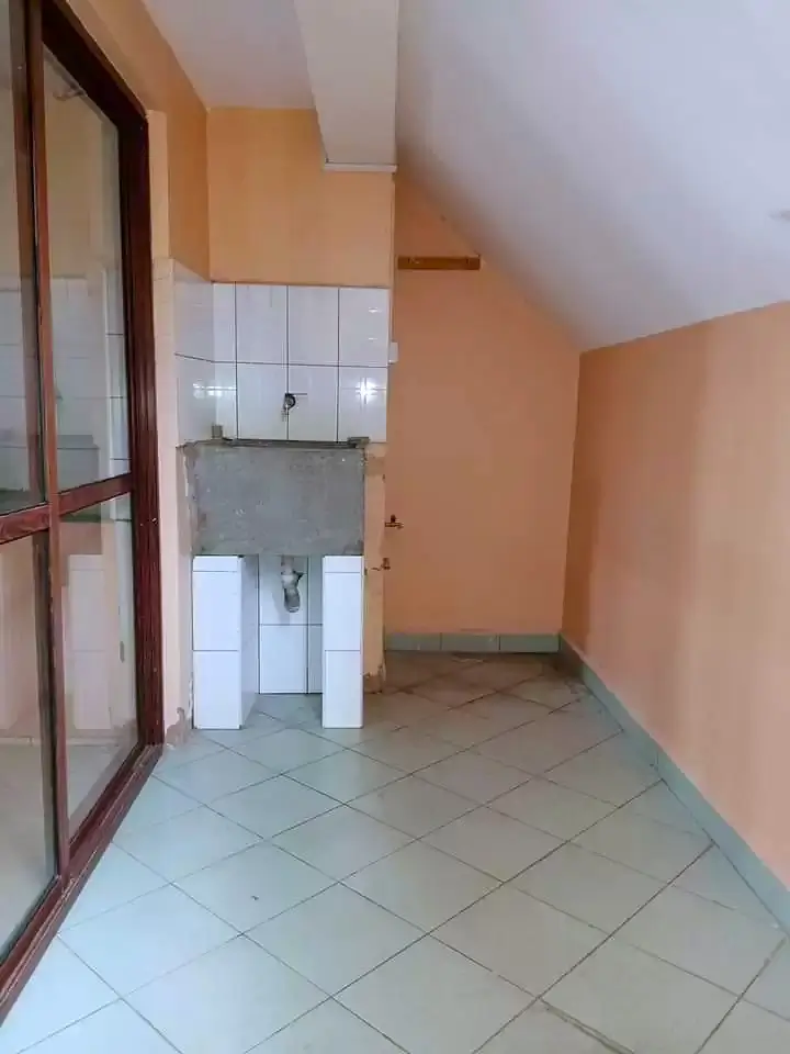 Small bathroom with white tile flooring and peach walls