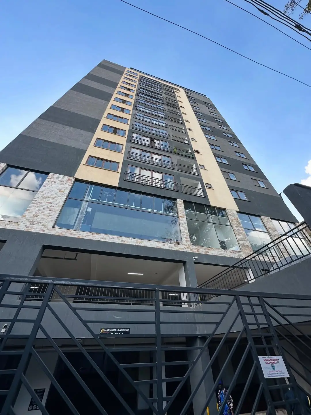 Modern multi-story apartment building with glass and brick facade