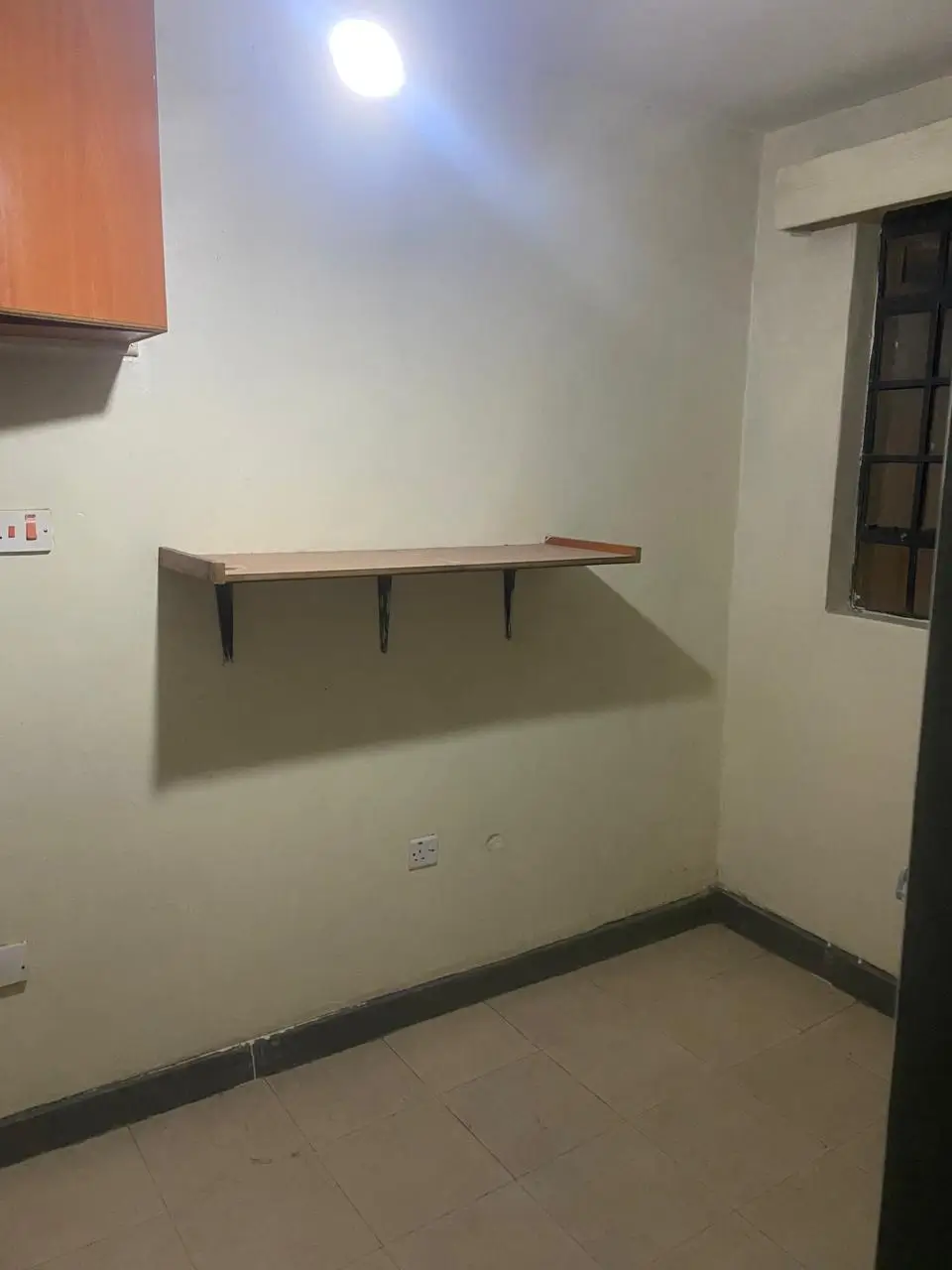 Compact utility room with wall-mounted shelf and storage