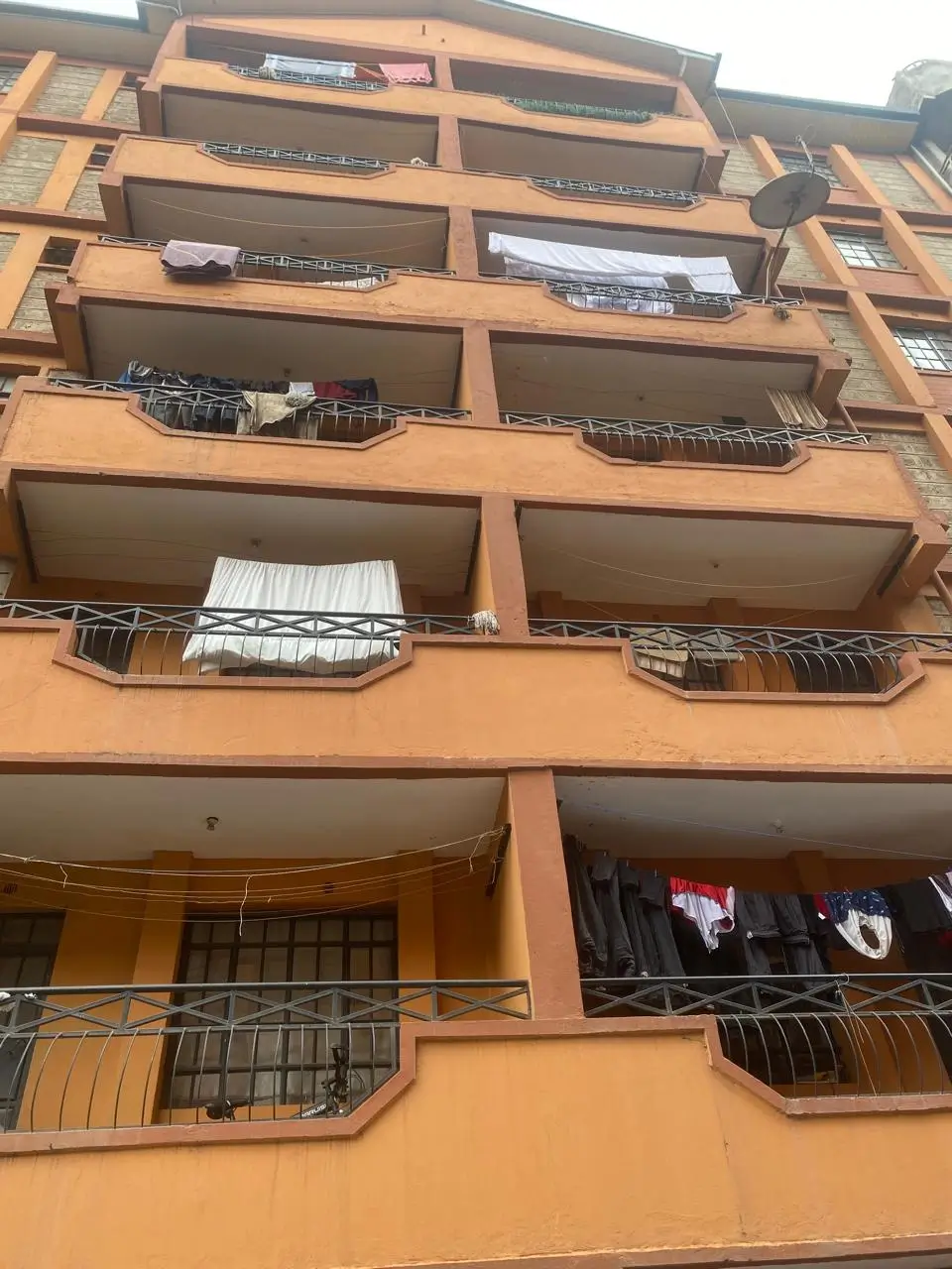 Multi-story residential building facade with balconies and laundry