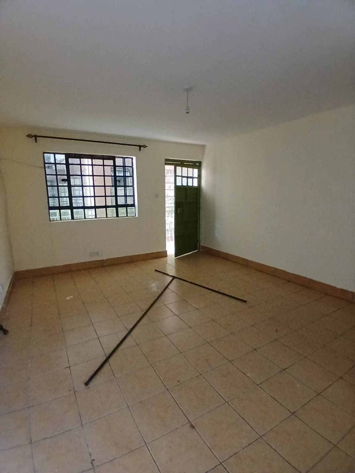 Empty living room with tiled floor and natural light