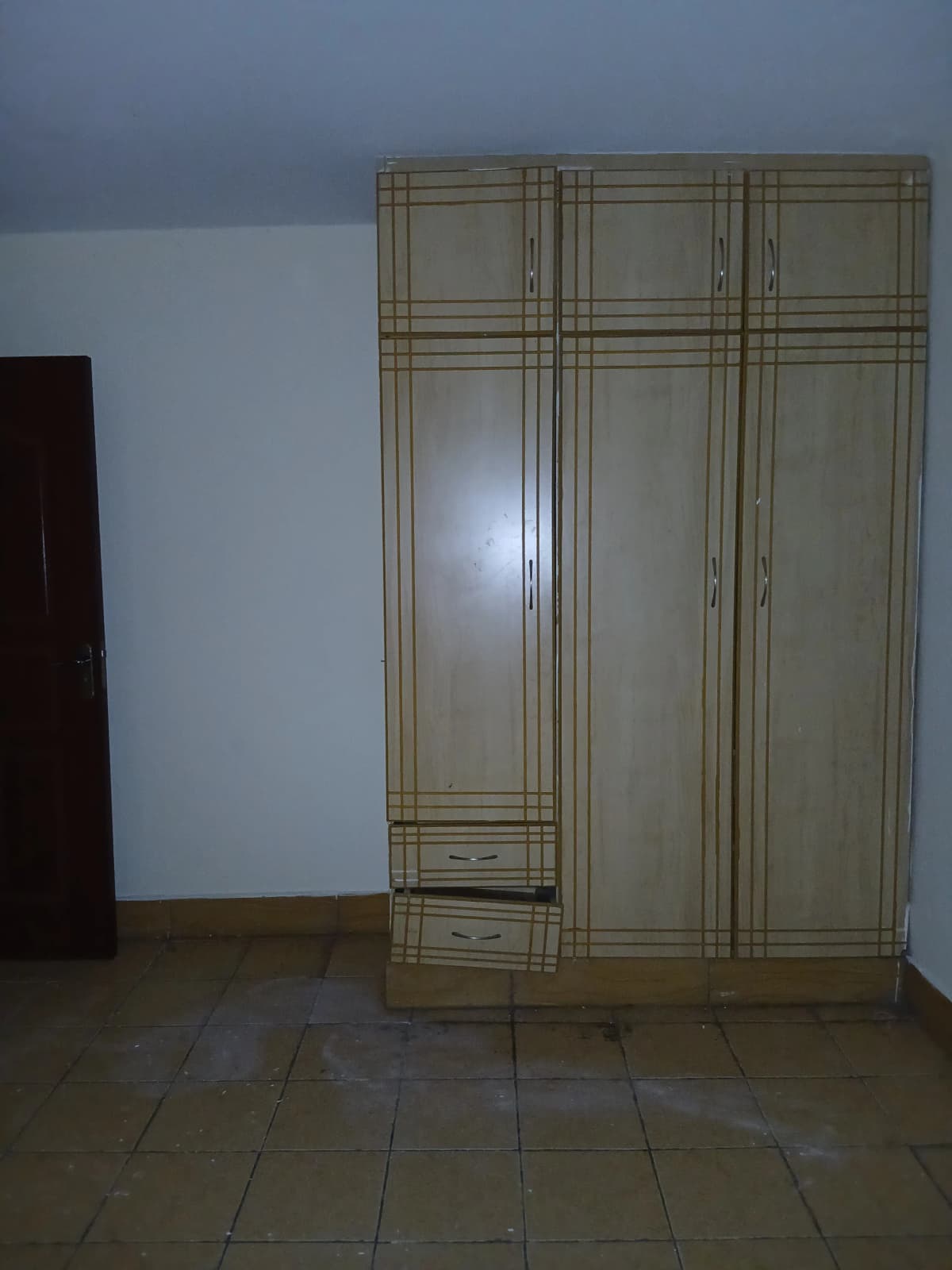 Bedroom with large built-in wardrobe and tiled floor