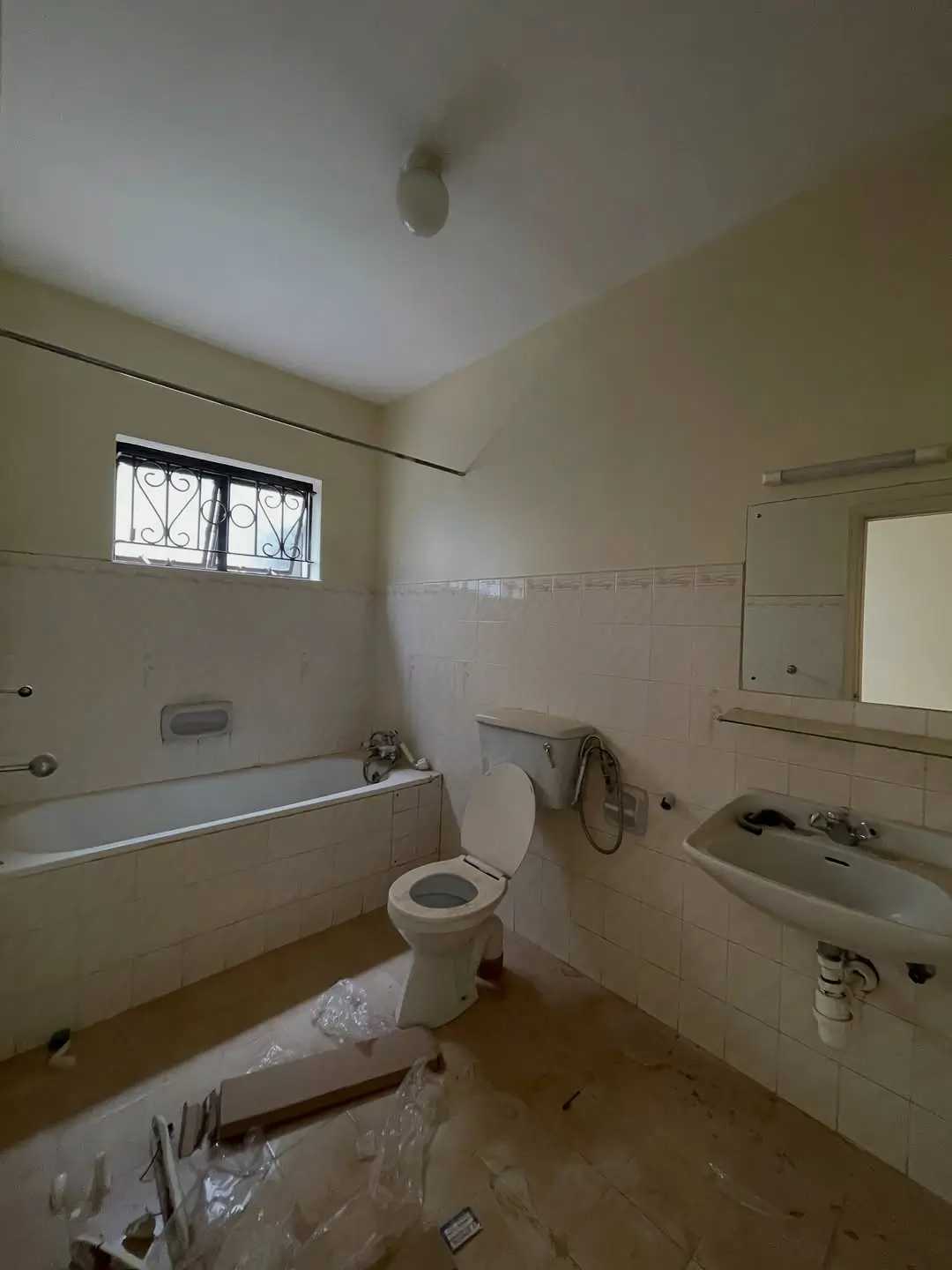 Bathroom with bathtub, toilet, sink and window