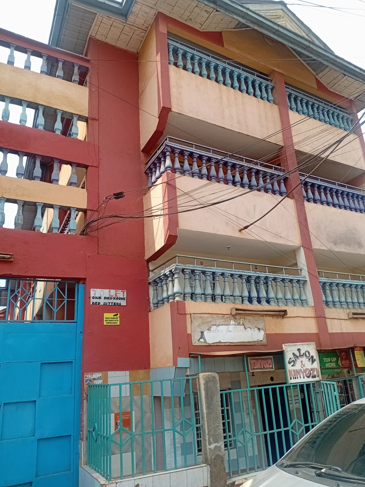 Multi-story residential building with red facade and balconies