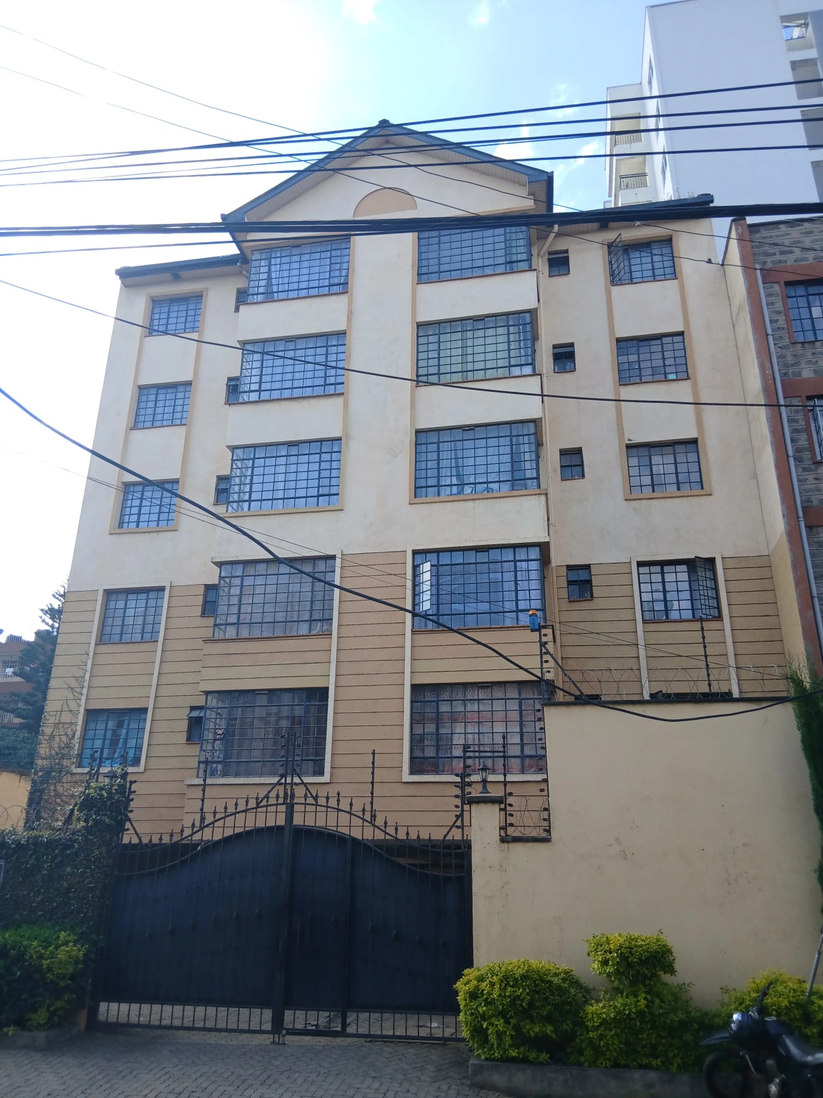 Multi-story residential building facade with blue-framed windows