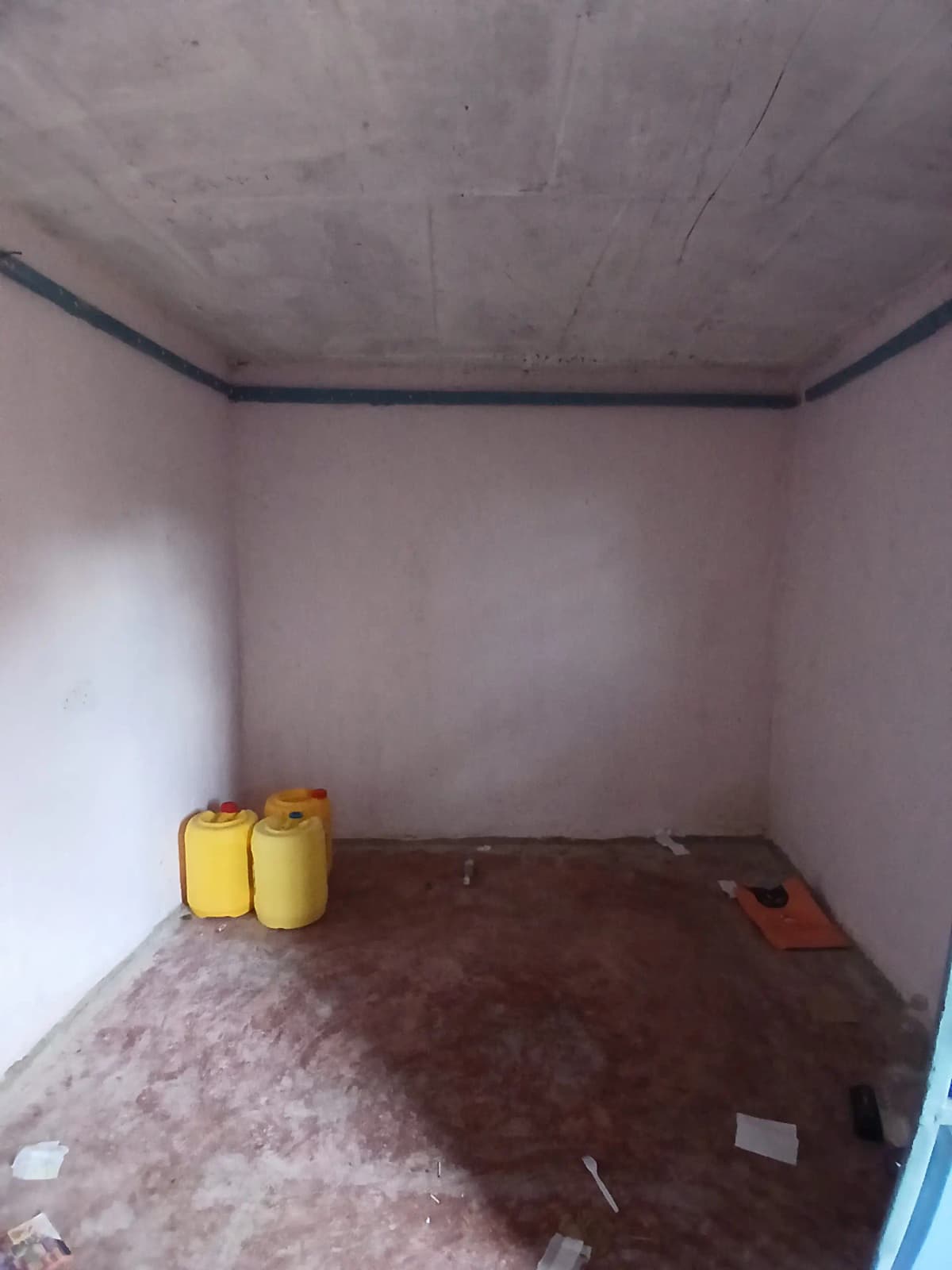 Empty room under construction with yellow containers