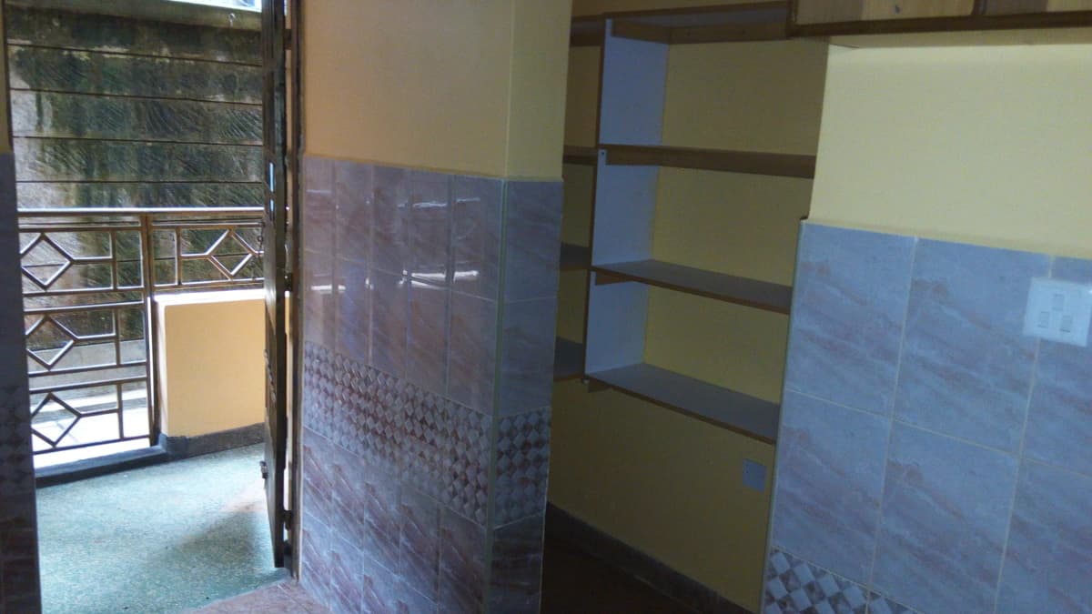Bathroom with blue tile walls and open door entry
